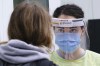 Efforts by provinces and health authorities to recruit nurses from other parts of the country won't solve nursing shortages unless they address the reasons people are leaving the profession, a nurses association said. A nurse greets a woman at a walk-in clinic in Montreal, on Tuesday, September 29, 2020. THE CANADIAN PRESS/Paul Chiasson
