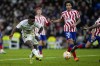 Real Madrid's Vinicius Junior shoots the ball to score his side's third goal during the Spanish Copa del Rey quarter final soccer match between Real Madrid and Atletico Madrid at Santiago Bernabeu stadium in Madrid, Thursday, Jan. 26, 2023. Real Madrid won 3-1. (AP Photo/Bernat Armangue)