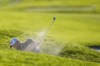 Jon Rahm, of Spain, hits out of a bunker on the 17th hole of the South Course at Torrey Pines during the third round of the Farmers Insurance Open golf tournament, Friday, Jan. 27, 2023, in San Diego. (AP Photo/Gregory Bull)