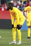 Barcelona's Ousmane Dembele hold his knees after being injured during the Spanish La Liga soccer match between Girona and FC Barcelona at the Montilivi stadium in Girona, Spain, Saturday, Jan. 28, 2023. (AP Photo/Joan Monfort)