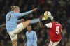 Manchester City's Erling Haaland, left, challenges for the ball with Arsenal's Thomas Partey during the English FA Cup 4th round soccer match between Manchester City and Arsenal at the Etihad Stadium in Manchester, England, Friday, Jan. 27, 2023. (AP Photo/Dave Thompson)