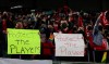 FILE - Portland Thorns fans hold signs during the first half of the team's NWSL soccer match against the Houston Dash in Portland, Ore., Oct. 6, 2021. On Monday, Jan. 30, 2023, U.S. Soccer introduced a Safe Soccer program that will require comprehensive vetting of individuals involved in the sport as the federation continues to address its investigation into coach misconduct in the National Women's Soccer League. (AP Photo/Steve Dipaola, File)