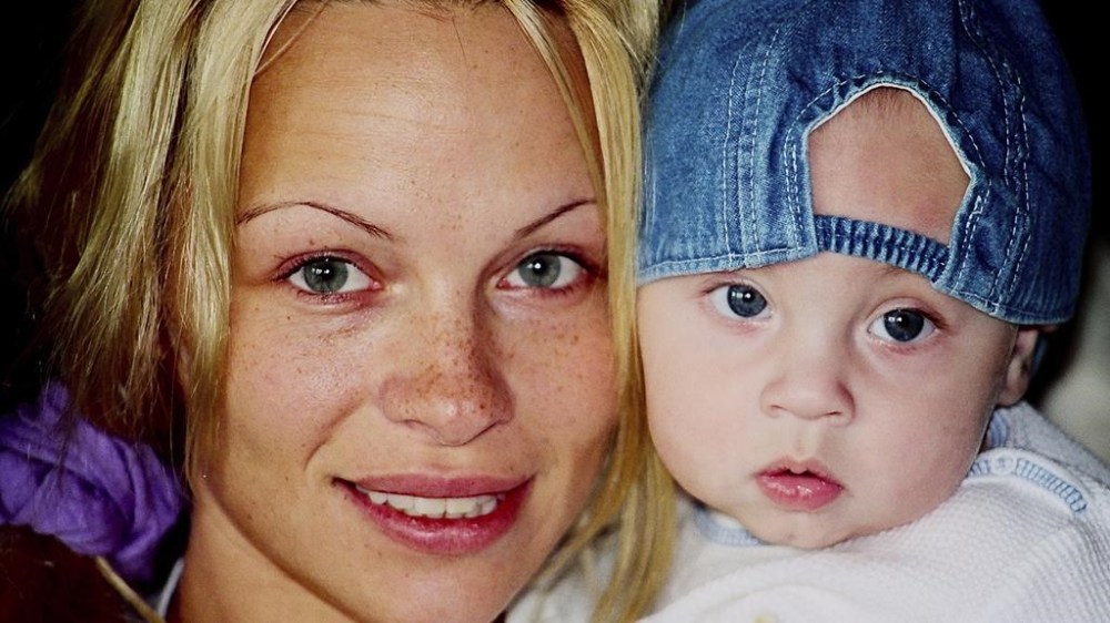 This image released by Netflix shows Pamela Anderson, left, and Brandon Thomas Lee in a a family photo from the documentary