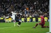 Real Madrid's Vinicius Junior, left, takes a shot on goal past Real Sociedad's Igor Zubeldia, center, during the Spanish La Liga soccer match between Real Madrid and Real Sociedad, at the Santiago Bernabeu stadium in Madrid, Sunday, Jan. 29, 2023. (AP Photo/Manu Fernandez)