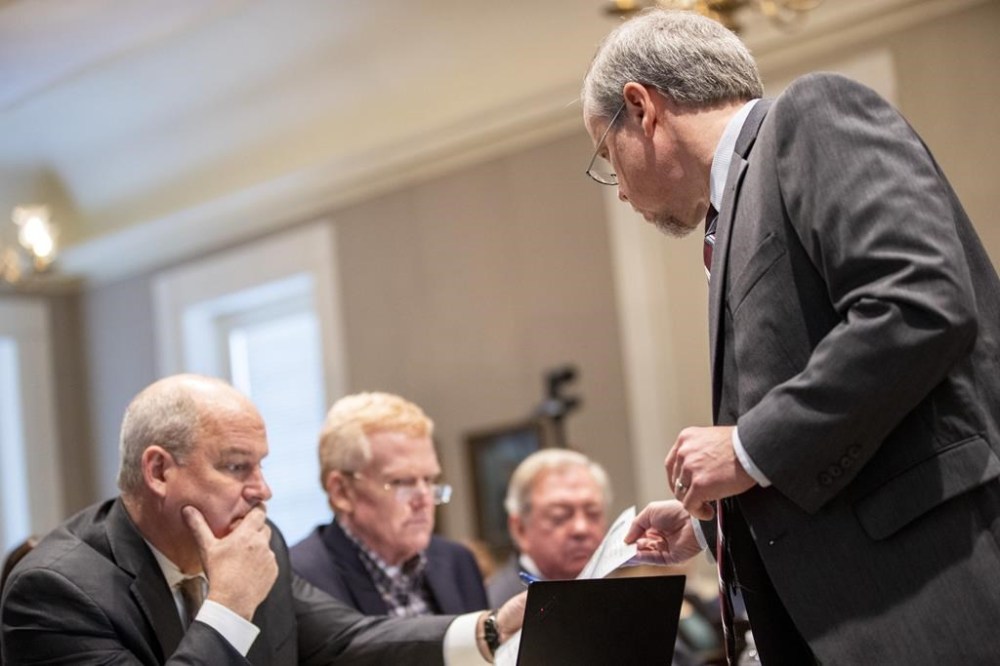 Creighton Waters, a prosecutor for the S.C. Attorney General's office hands off a photograph to defense attorney Jim Griffin, Alex Murdaugh and Dick Harpootlian in the double murder trial of Alex Murdaugh at the Colleton County Courthouse in Walterboro, S.C., Monday, Jan. 30, 2023. (Andrew J. Whitaker/The Post And Courier via AP, Pool)