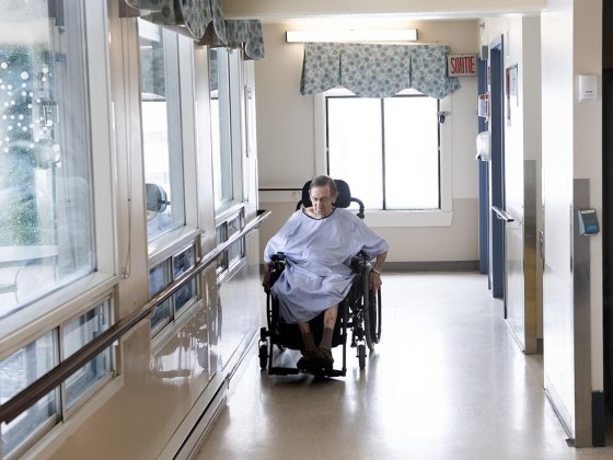 A resident makes his way along a corridor at Idola Saint-Jean long-term care home in Laval, Que. (Graham Hughes / The Canadian Press files)