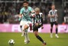 Southampton's Che Adams, left, and Newcastle's Bruno Guimaraes battle for the ball during their English League Cup Semi Final second leg soccer match at St. James's Park, Newcastle upon Tyne, England, Tuesday, Jan. 31, 2023. (Owen Humphreys/PA via AP)