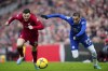 Liverpool's Andrew Robertson challenges for the ball with Chelsea's Hakim Ziyech during the English Premier League soccer match between Liverpool and Chelsea at Anfield stadium in Liverpool, England, Saturday, Jan. 21, 2023. (AP Photo/Jon Super)