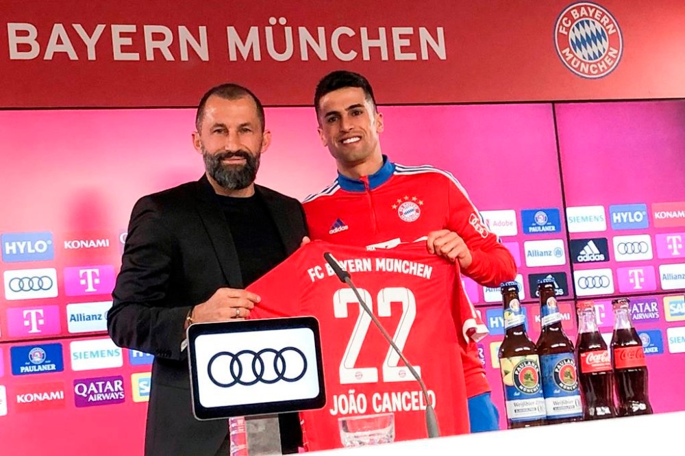 Hasan Salihamidzic, left, Sports Director of FC Bayern Munich, presents new signing Joao Cancelo at a press conference in Munich, Germany, Tuesday, Jan. 31, 2023. (Christian Kunz/dpa via AP)