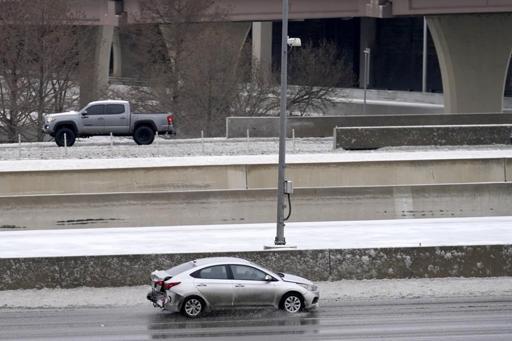 Drivers slowly navigate through icy road conditions on LBJ 635 Freeway, Tuesday, Jan. 31, 2023, in Dallas. (AP Photo/Tony Gutierrez)