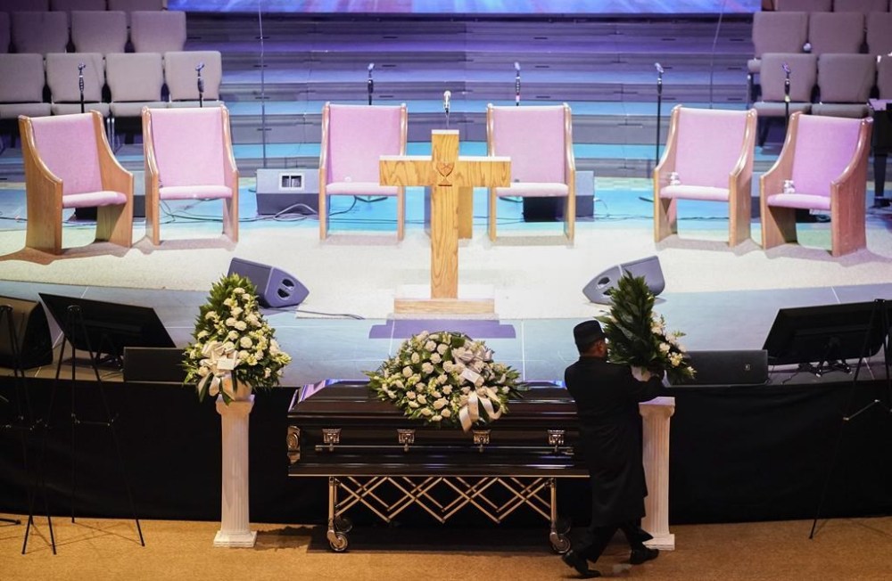 A man arranges flowers around Tyre Nichols' casket at Mississippi Boulevard Christian Church in Memphis, Tenn., on Wednesday, Feb. 1, 2023. Nichols died following a brutal beating by Memphis police after a traffic stop. (Andrew Nelles/The Tennessean via AP, Pool)