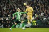 Barcelona's Robert Lewandowski, right, heads the ball past Betis' German Pezzella during a Spanish La Liga soccer match between Real Betis and Barcelona at the Benito Villamarin stadium in Seville, Spain, Wednesday, Feb. 1, 2023. (AP Photo/Jose Breton)