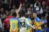 Valencia's Gabriel Paulista, right, is shown a red car by referee Javier Alberola Rojas during the Spanish La Liga soccer match between Real Madrid and Valencia at Santiago Bernabeu stadium in Madrid, Thursday, Feb. 2, 2023. (AP Photo/Bernat Armangue)