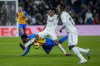 Real Madrid's Eder Militao, center, vies for the ball with Valencia's Yunus Musah during the Spanish La Liga soccer match between Real Madrid and Valencia at Santiago Bernabeu stadium in Madrid, Thursday, Feb. 2, 2023. (AP Photo/Bernat Armangue)