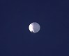ADDS PENTAGON RESPONSE THAT IT WOULD NOT CONFIRM - A high altitude balloon floats over Billings, Mont., on Wednesday, Feb. 1, 2023. The U.S. is tracking a suspected Chinese surveillance balloon that has been spotted over U.S. airspace for a couple days, but the Pentagon decided not to shoot it down due to risks of harm for people on the ground, officials said Thursday, Feb. 2, 2023. The Pentagon would not confirm that the balloon in the photo was the surveillance balloon. (Larry Mayer/The Billings Gazette via AP)