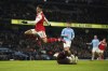 Manchester City's goalkeeper Stefan Ortega, bottom, saves on Arsenal's Gabriel Martinelli during the English FA Cup 4th round soccer match between Manchester City and Arsenal at the Etihad Stadium in Manchester, England, Friday, Jan. 27, 2023. (AP Photo/Dave Thompson)