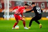 FC Augsburg's Dion Beljo, left, and Bayer Leverkusen's Adam Hlozek battle for the ball during the Bundesliga soccer match between FC Augsburg and Bayer Leverkusen at WWK Arena, Augsburg, Germany, Friday Feb. 3, 2023. (Matthias Balk/dpa via AP)
