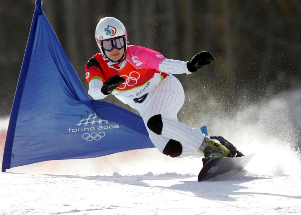 FILE - United States Rosey Fletcher clears a gate during the women's snowboard parallel giant slalom race at the Turin 2006 Winter Olympic Games in Bardonecchia, Italy, on Feb. 23, 2006. Olympic bronze medalist Rosey Fletcher filed a lawsuit accusing former snowboard coach Peter Foley of sexually assaulting, harassing and intimidating members of his team for years, while the organizations overseeing the team did nothing to stop it. Fletcher is a plaintiff in one of two lawsuits filed in U.S. District Court in Los Angeles on Thursday, Feb. 2, 2023. (AP Photo/Charles Krupa, File)