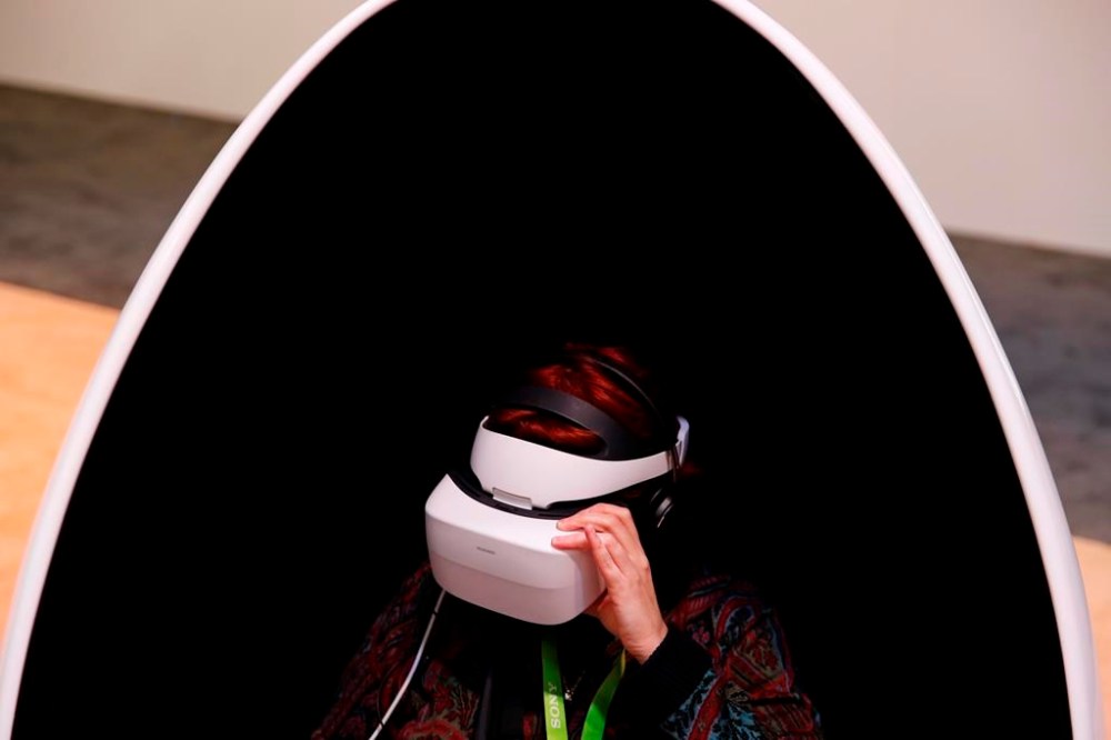 A woman wears Huawei VR2 goggles at the Huawei booth during CES International, Tuesday, Jan. 9, 2018, in Las Vegas. GrinhausՠToronto law firm is one of a growing group of companies setting up offices in a virtual world called the metaverse to push the envelope and learn more about the emerging technology. THE CANADIAN PRESS/AP, John Locher
