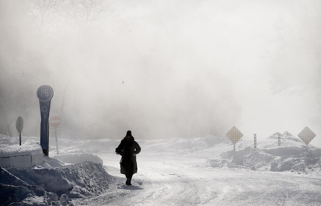 A person walks through a park during frigid temperatures in Montreal, Saturday, February 4, 2023.&nbsp;Environment Canada has issued extreme cold weather alerts impacting six provinces — from Ontario to Newfoundland and Labrador, and communities in Nunavut and the Northwest Territories.&nbsp;THE CANADIAN PRESS/Graham Hughes