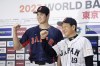 Shohei Ohtani, left, of Los Angeles Angels, and Japan's manager Hideki Kuriyama, right, pose together during a press conference in Tokyo, Japan, Friday, Jan. 6, 2023. Japan officials on Friday named 12 members of the World Baseball Classic team that will represent the country. The World Baseball Classic will be played March 8-21.(Iori Sagisawa/Kyodo News via AP)