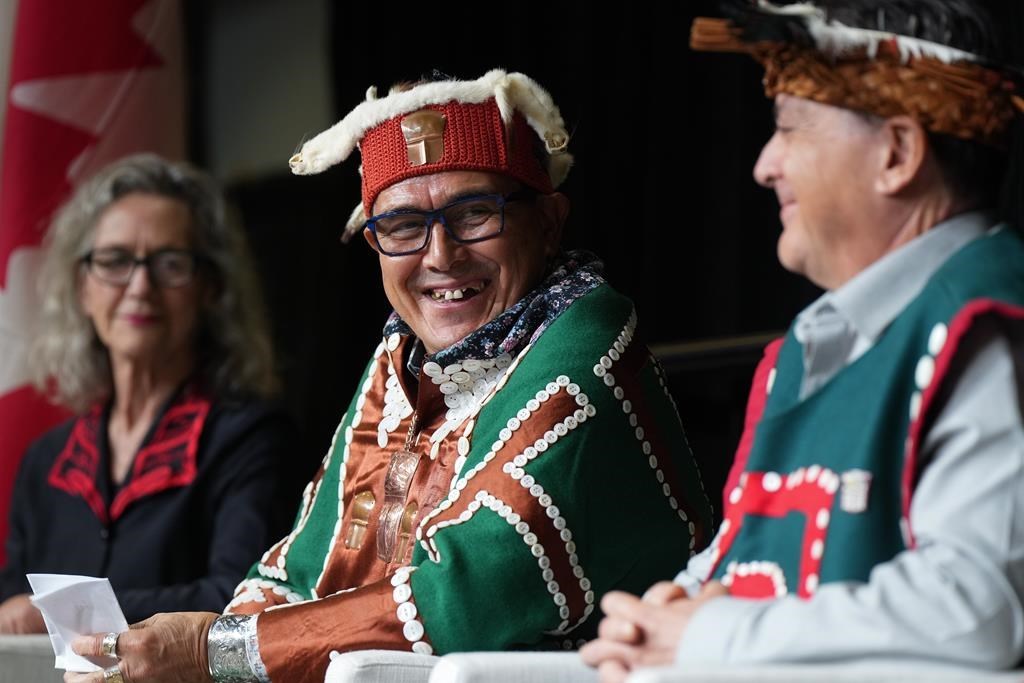 Chief John Powell, centre, of the Mamalilikulla First Nation, sits with Joyce Murray, back left, Minister of Fisheries, Oceans and the Canadian Coast Guard, and former chief Richard Sumner during an announcement about a new marine refuge in the Gwaxdlala/Nalaxdlala (Lull Bay/Hoeya Sound) area in Knight Inlet on B.C.'s central coast, at the International Marine Protected Areas Congress (IMPAC5) in Vancouver, on Sunday, February 5, 2023. The federal and British Columbia governments alongside 15 coastal First Nations have officially endorsed the blueprint for a vast network of marine protected areas along the west coast of Canada. THE CANADIAN PRESS/Darryl Dyck