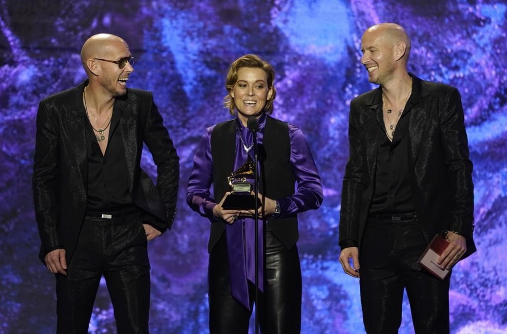 Phil Hanseroth, from left, Brandi Carlile and Tim Hanseroth accept the award for best rock song for
