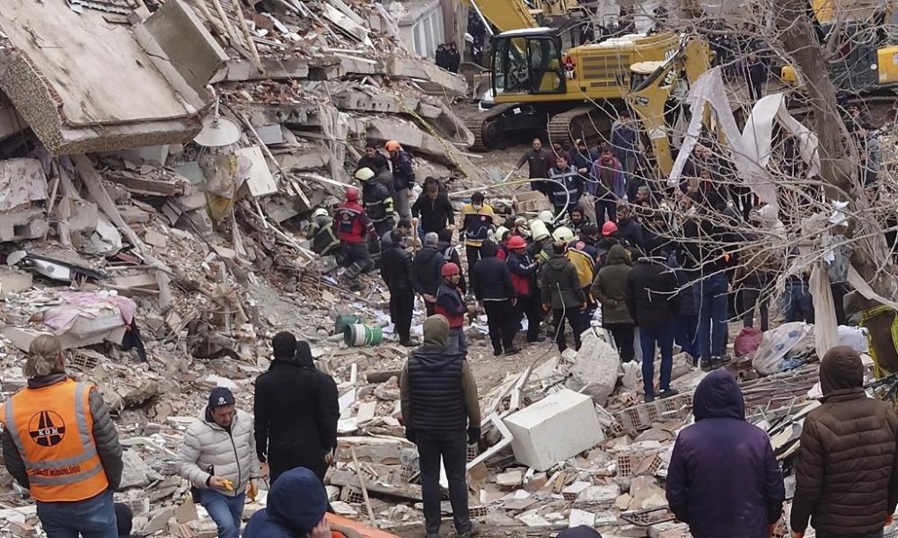 Rescue workers search for survivors under the rubble of a collapsed building in Diyarbakir, southeastern Turkey, Monday, Feb. 6, 2023. A powerful earthquake that struck southeast Turkey and northern Syria has killed more than 640 people with hundreds injured. The toll is expected to rise as rescuers search for dead and survivors in dozens of collapsed buildings across the region. (AP Photo/Mahmut Bozarsan)