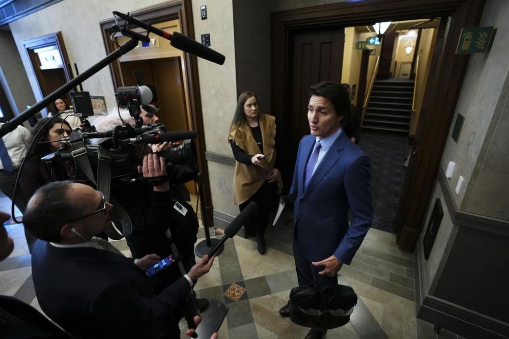 Prime Minister Justin Trudeau talks to reporters in the foyer as he arrives for question period in the House of Commons on Parliament Hill in Ottawa on Monday, Feb. 6, 2023. THE CANADIAN PRESS/Sean Kilpatrick