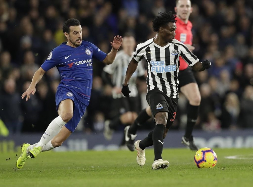 FILE - Chelsea's Pedro, left, and Newcastle United's Christian Atsu vie for the ball during the English Premier League soccer match between Chelsea and Newcastle United at Stamford Bridge stadium in London, on, Jan. 12, 2019. Former Chelsea and Newcastle forward Christian Atsu is missing and believed to be trapped under rubble following the powerful earthquake that struck Turkey on Monday and left more than 2,500 people dead. The Ghana international plays for Turkish club Hatayspor and a club spokesman says he is thought to be in a building that was destroyed. (AP Photo/Matt Dunham, File)