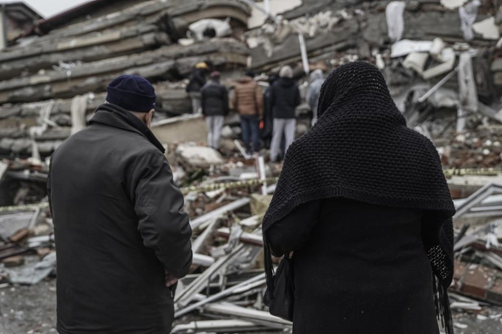 People and emergency teams search for people in the rubble in a destroyed building in Gaziantep, Turkey, Monday, Feb. 6, 2023. A powerful quake has knocked down multiple buildings in southeast Turkey and Syria and many casualties are feared. (AP Photo/Mustafa Karali)
