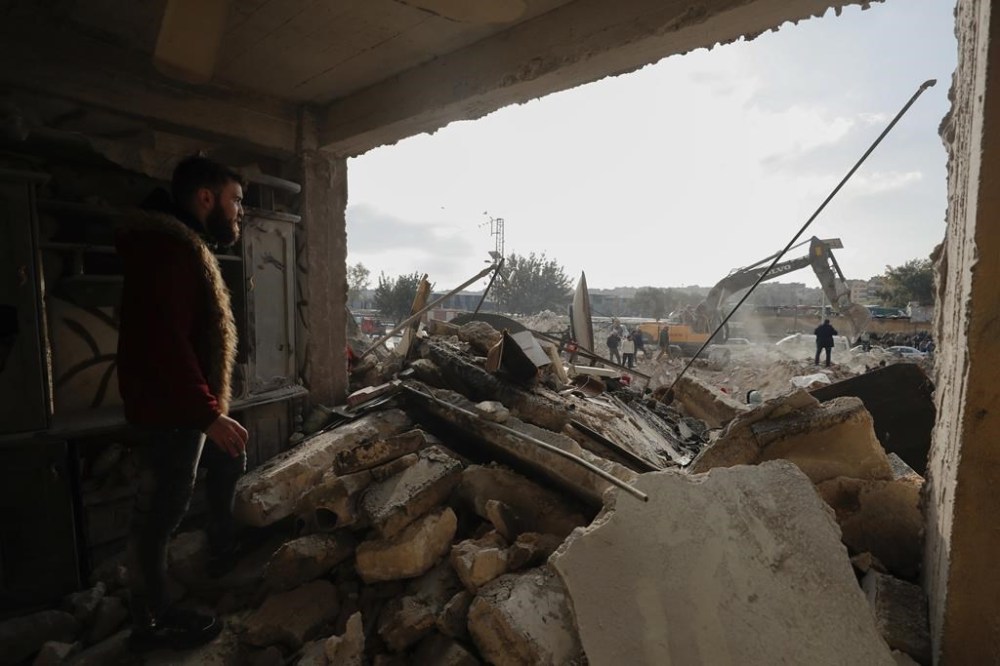 Rescue teams search through the wreckage of collapsed buildings in Aleppo, Syria, Tuesday, Feb. 7, 2023. Rescuers raced Tuesday to find survivors in the rubble of thousands of buildings brought down by a powerful earthquake and multiple aftershocks that struck eastern Turkey and neighboring Syria. (AP Photo/Omar Sanadiki)