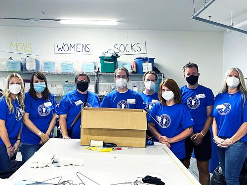 Manitoba Blue Cross employees volunteering to help individuals affected by homelessness in Winnipeg.