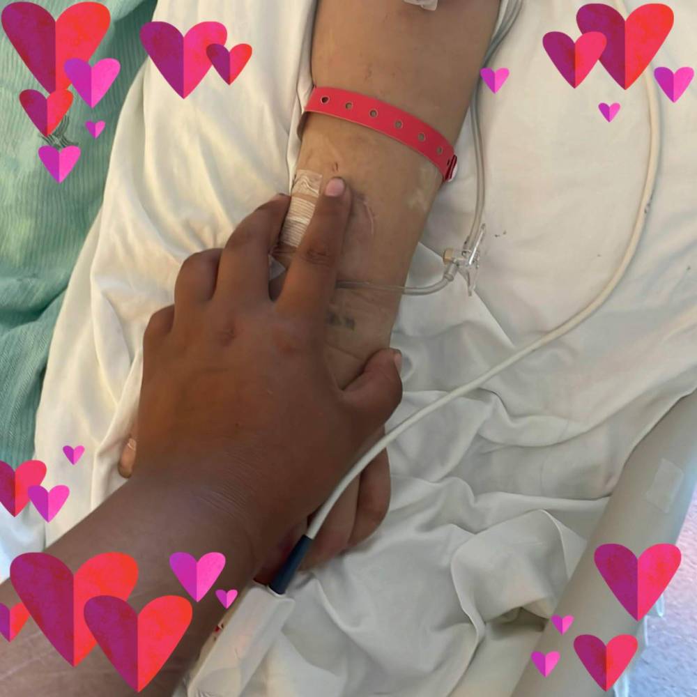 SUPPLIED
Naturelle Cook holds the hand of her mother Melissa Cook shortly before her life support was removed.