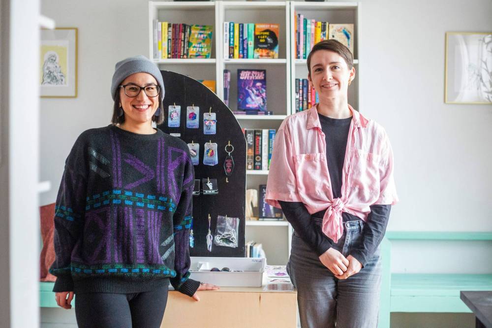 Megan Wray (left) and Meghan Malcolm, Willow Press owner, stand in the shop. Malcolm and Wray have visited schools for writing tutorials and book readings. Willow also hosts workshops on sex education and art therapy, among other things. (Mikaela MacKenzie / Winnipeg Free Press)