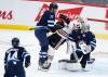 JOHN WOODS / THE CANADIAN PRESS
                                Winnipeg Jets’ Adam Lowry (17) pushes Chicago Blackhawks’ Jason Dickinson (17) into goaltender Connor Hellebuyck (37) as he attempts to clear him during third period NHL action in Winnipeg, Saturday, February 11, 2023.