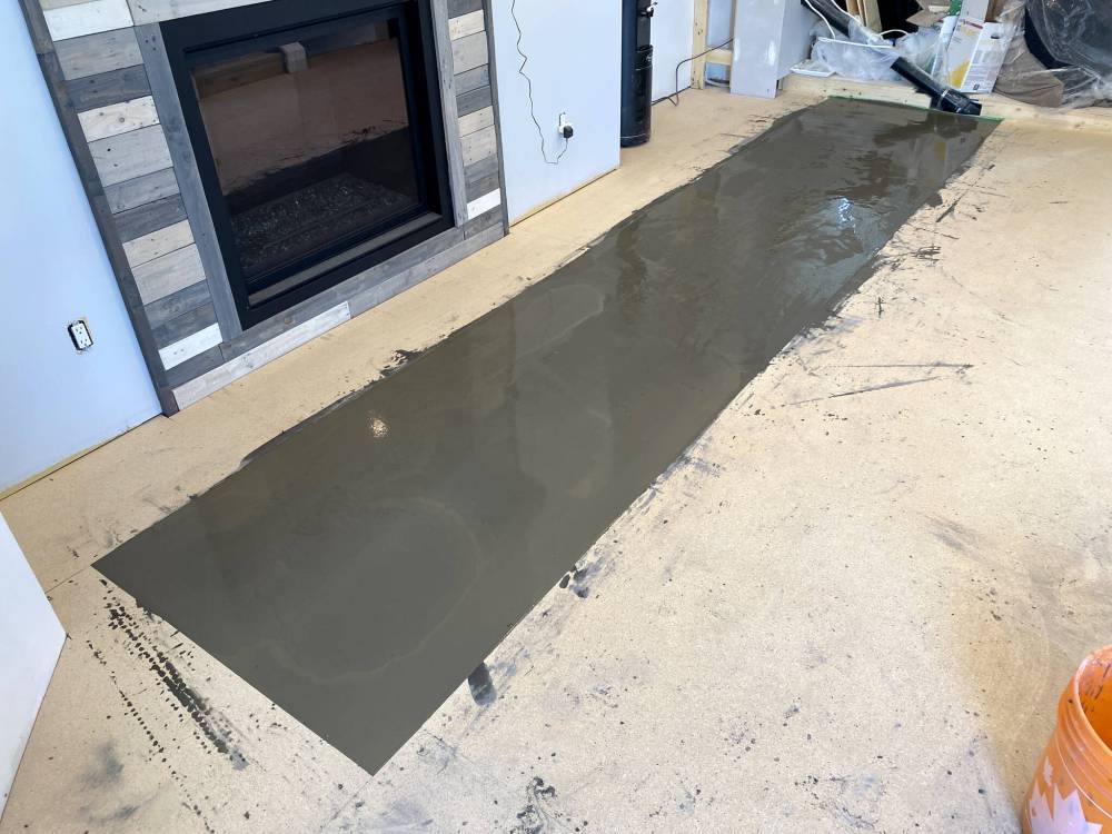 Photos by Marc LaBossiere / Winnipeg Free Press
                                Self-levelling compound is used to eliminate a hump along one seam of the adjacent plywood subfloor.