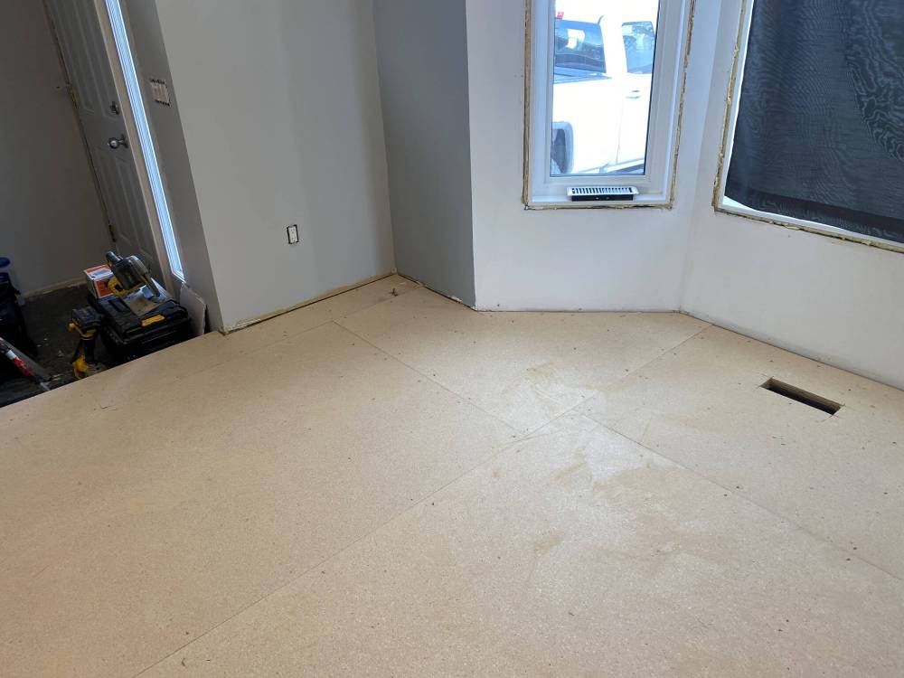A typical secondary subfloor installation involves securing pro-board to the plywood subfloor throughout.