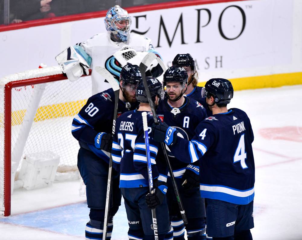 FRED GREENSLADE / THE CANADIAN PRESS
Winnipeg Jets’ Pierre-Luc Dubois (80) celebrates his goal against the Seattle Kraken with Nikolaj Ehlers (27), Josh Morrissey (44) and Neal Poink (4) during third period NHL action in Winnipeg.