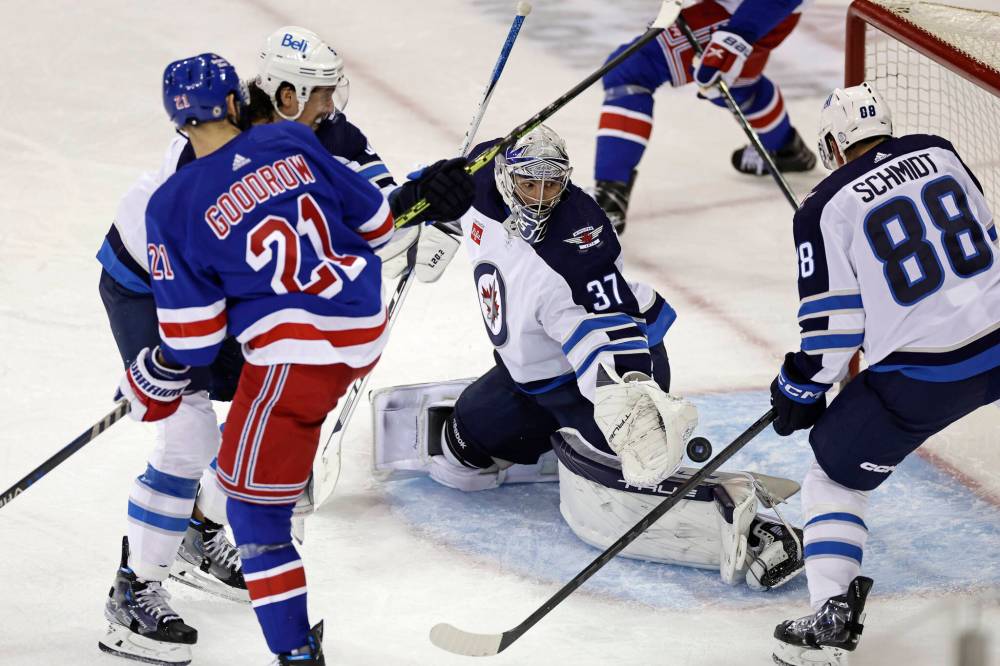 Winnipeg Jets goaltender Connor Hellebuyck makes a save in front of New York Rangers centre Barclay Goodrow (21) in the third period Monday in New York. The Jets won 4-1. (AP Photo/Adam Hunger)