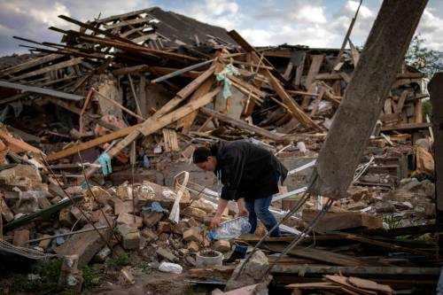 Emilio Morenatti / The Associated Press files
                                Anna Shevchenko, 35, waters the few flowers that survived in the garden of her home in Irpin, near Kyiv, last May. The house, built by her grandparents, was nearly completely destroyed by Russian bombing last March.