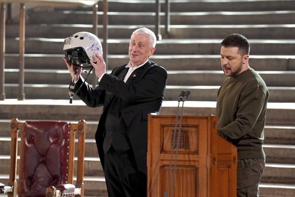 Speaker of the House of Commons, Sir Lindsay Hoyle, left, holds the helmet of one of the most successful Ukrainian pilots, inscribed with the words