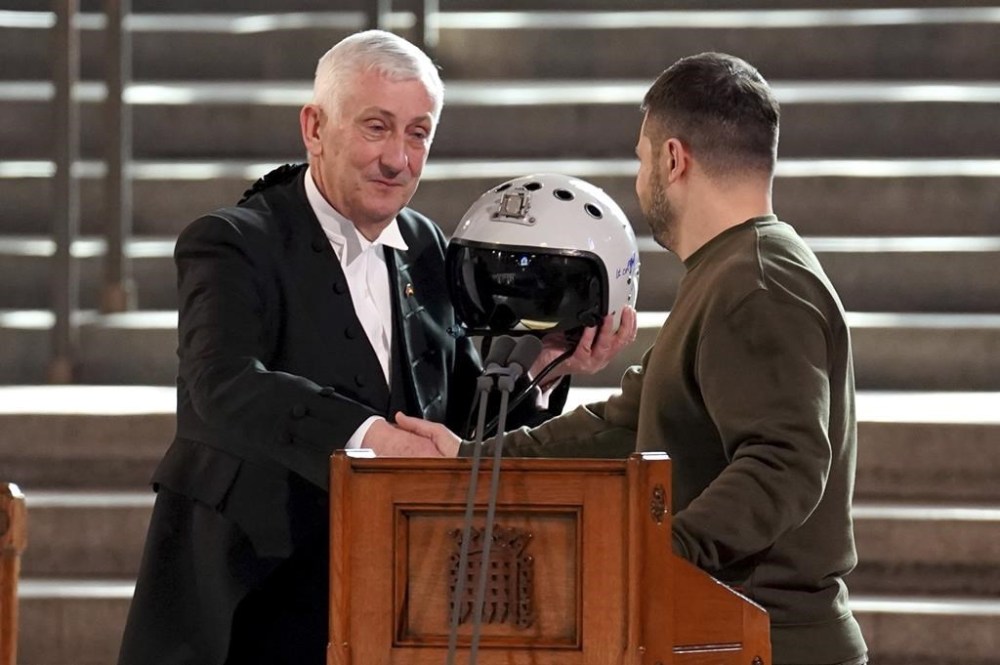 Speaker of the House of Commons, Sir Lindsay Hoyle, left, holds the helmet of one of the most successful Ukrainian pilots, inscribed with the words