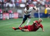 Vancouver Whitecaps' Cristian Dajome, left, is upended by Toronto FC's Lukas MacNaughton during the first half of the Canadian Championship soccer final, in Vancouver, on Tuesday, July 26, 2022. Dajome scored twice in the second half to help the Vancouver Whitecaps blank Toronto FC 3-0 in pre-season play Wednesday at the Coachella Valley Invitational. THE CANADIAN PRESS/Darryl Dyck