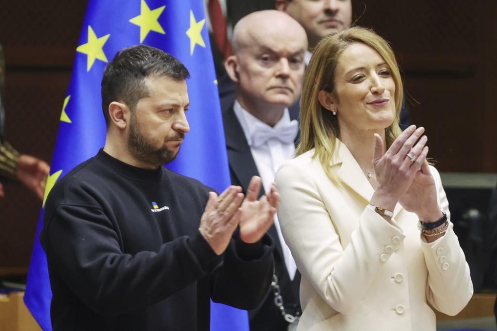 Ukraine's President Volodymyr Zelenskyy, left, and European Parliament's President Roberta Metsola, right, applaud during an EU summit at the European Parliament in Brussels, Belgium, Thursday, Feb. 9, 2023. On Thursday, Zelenskyy will join EU leaders at a summit in Brussels, which German Chancellor Olaf Scholz described as a