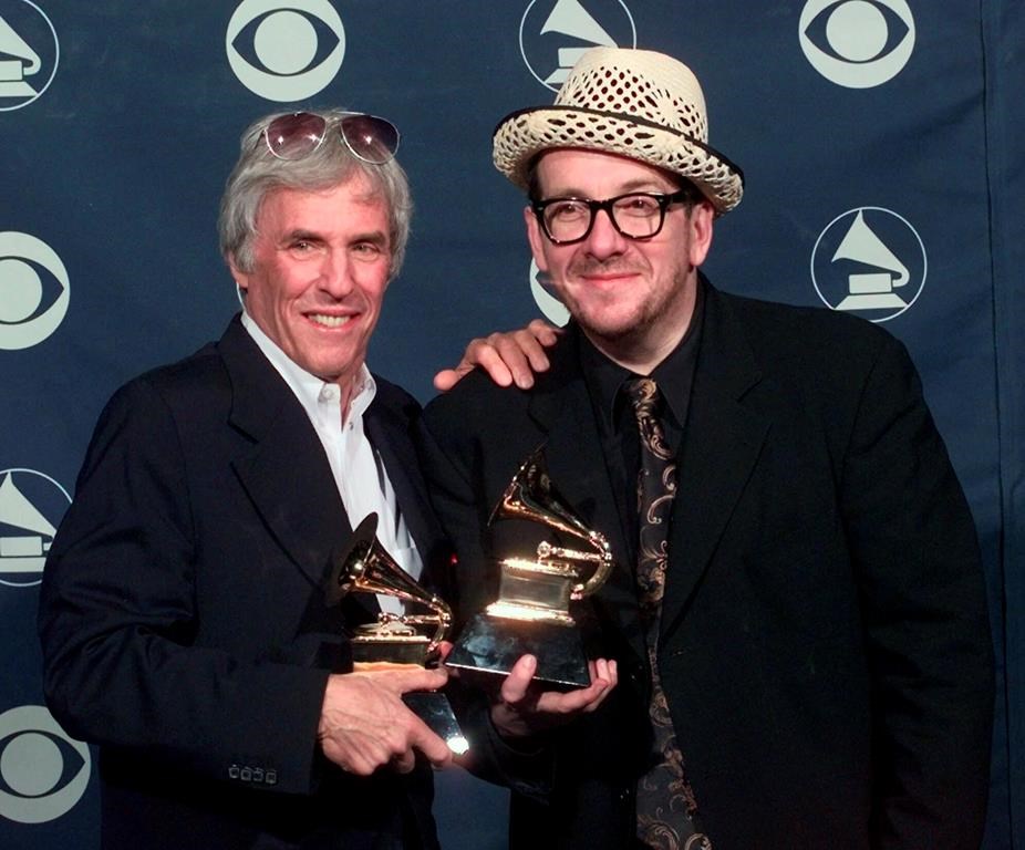 FILE - Burt Bacharach, left, and Elvis Costello hold their awards for best pop collaboration with vocals with