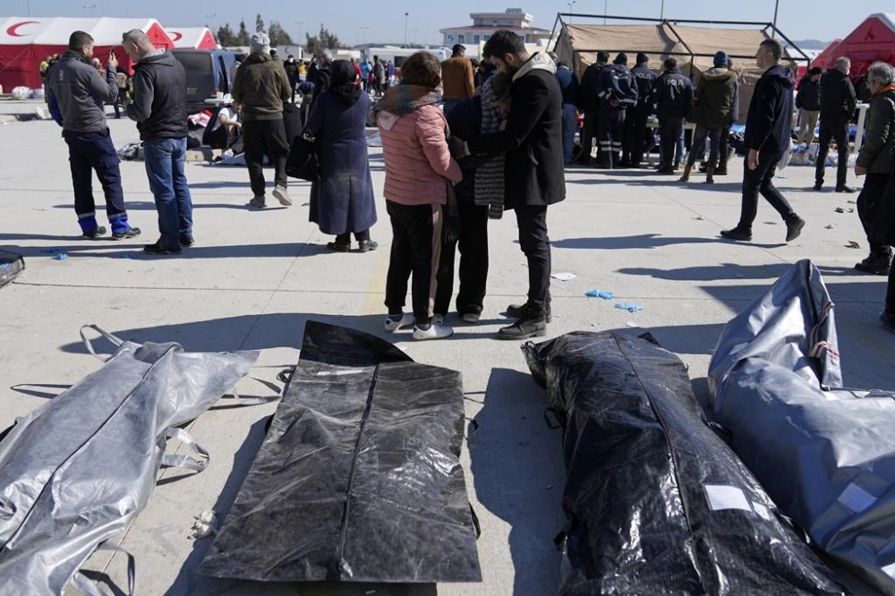 People mourn over the bodies of earthquake victims outside a hospital in Antakya, southeastern Turkey, Thursday, Feb. 9, 2023. Immigration Minister Sean Fraser says Canada may fast track applications to come to Canada for people in the earthquake zones of Turkey and Syria. THE CANADIAN PRESS/AP-Khalil Hamra