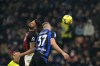 AC Milan's Olivier Giroud, left, duels for the ball with Inter Milan's Milan Skriniar during the Serie A soccer match between Inter Milan and AC Milan at the San Siro Stadium, in Milan, Italy, Sunday, Feb. 5, 2023. (AP Photo/Antonio Calanni)