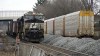 A Norfolk Southern freight train waits to pass through East Palenstine, Pa., Thursday, Feb. 9, 2023, where cleanup continues after a derailment Friday night. (AP Photo/Gene J. Puskar)