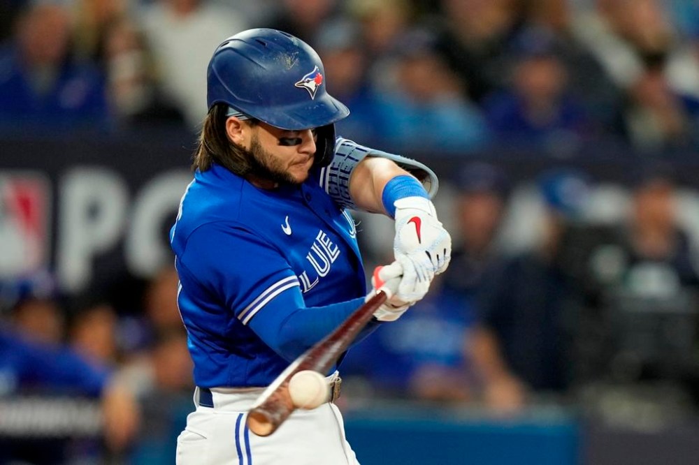 Toronto Blue Jays shortstop Bo Bichette (11) hits a double during fifth inning American League wild card MLB baseball action against the Seattle Mariners in Toronto on Saturday, October 8, 2022. The Toronto Blue Jays and shortstop Bo Bichette avoided arbitration after the two sides agreed to terms on a three-year, US$33.6 million contract, the team announced Thursday.THE CANADIAN PRESS/Frank Gunn